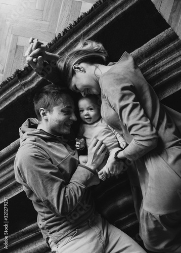 Portrait of a young happy family with the kid. Beautiful family hugs. Black and white