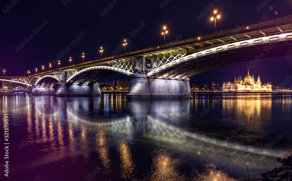 Fototapeta premium Fantastic Evening panorama. Famouse cityscape of Old Town in Budapest with Margaret bridge and Hungarian parliament during sunset. Creative image. Awesome picturesque scenery. Wonderful postcard