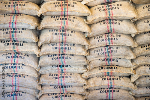Stack of burlap sacks Colombia coffee, backdrop, template.