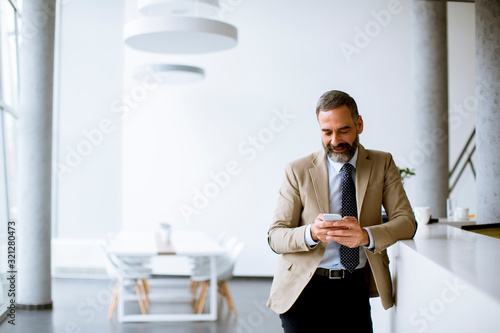 Senior businessman using mo...