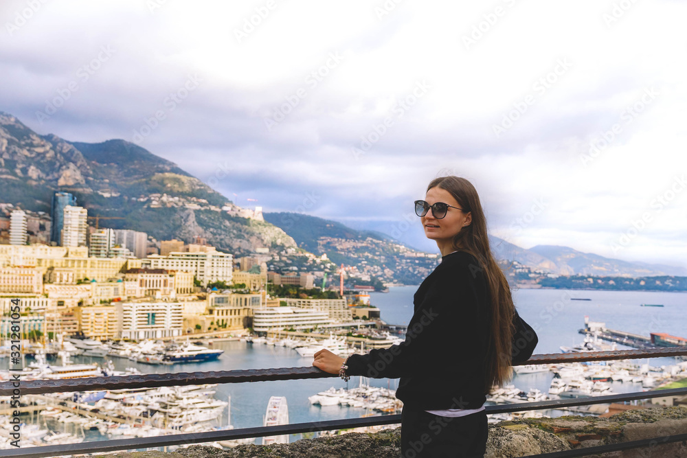 young woman enjoing panoramic view in Monaco near prince's palace in Monte Carlo of the French Riviera. Monaco Ville Harbour, Fontvieille.