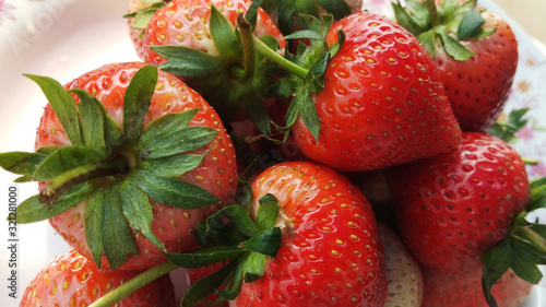Many fresh strawbery in the plate , close up top view