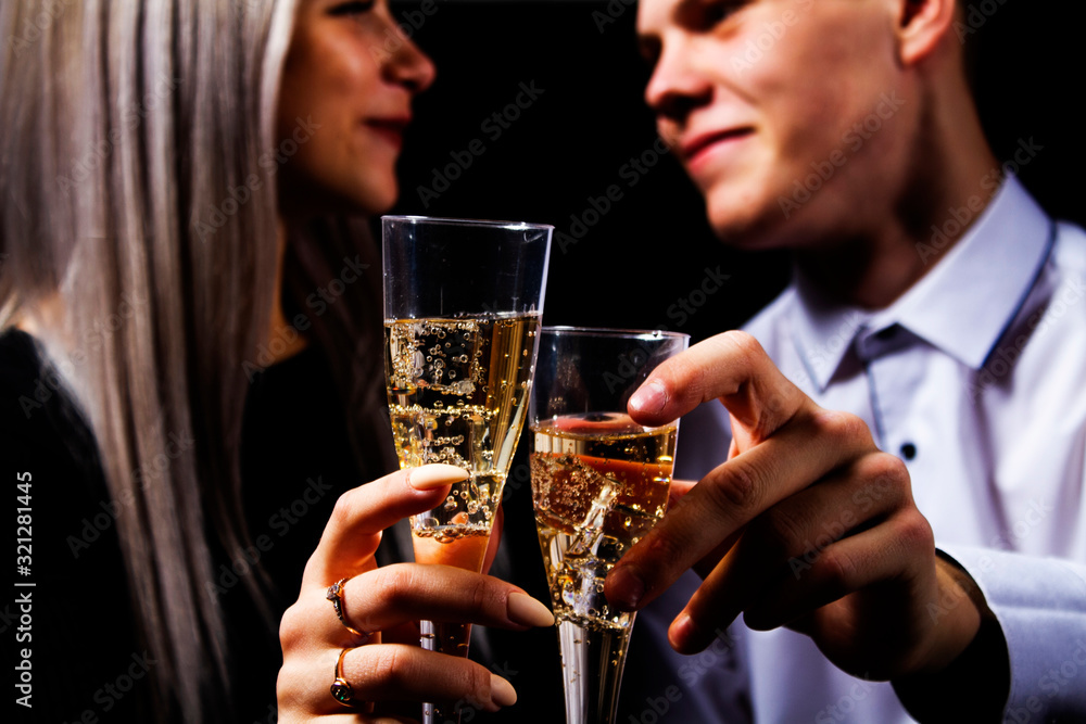 Close-up portrait of a loving couple greeting each other happy lovers day with glasses of champagne. Valentine's Day.