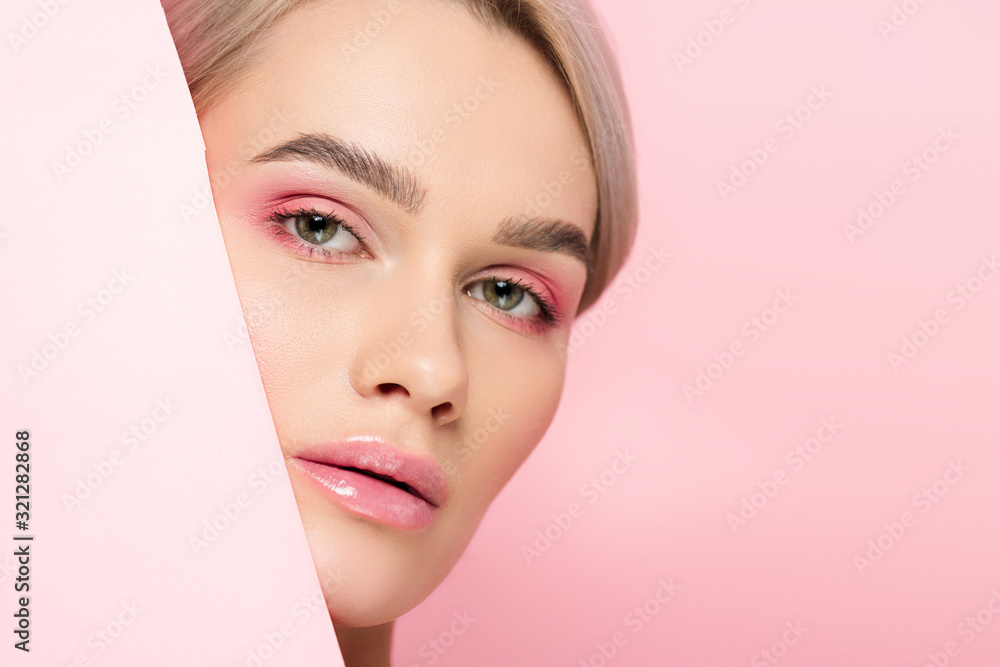 Φωτογραφία beautiful girl with pink makeup and piece of paper, isolated on pink