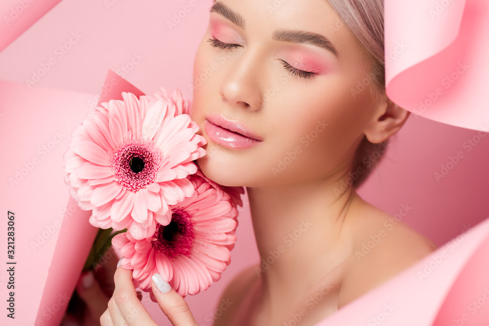 tender girl with closed eyes holding pink flowers in torn paper, on pink tender girl with closed eyes holding pink flowers in torn paper, on pink