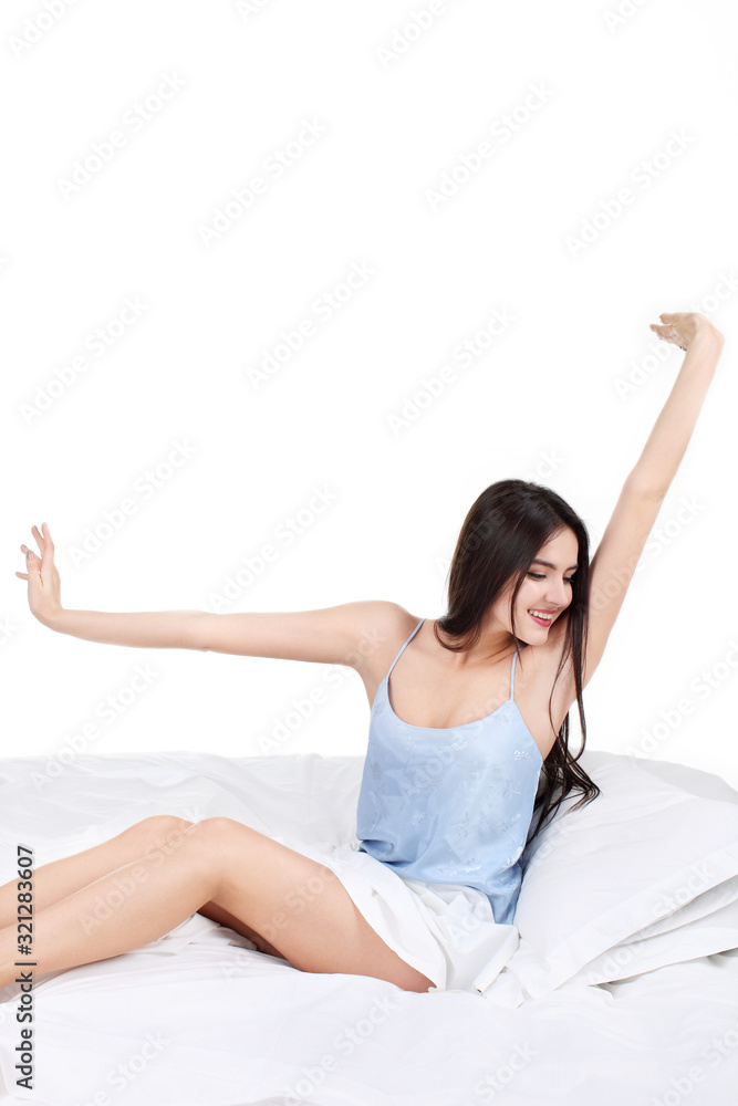 Portrait of a peaceful beautiful woman sitting on bed resting and happy. isolated on white background Portrait of a peaceful beautiful woman sitting on bed resting and happy. isolated on white background