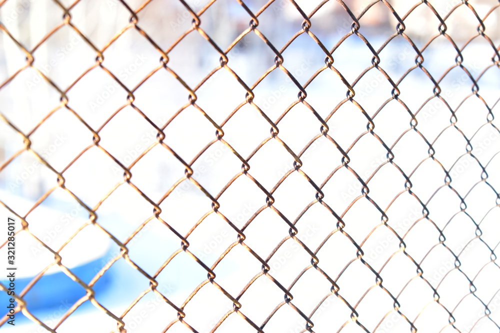 Fototapeta premium Iron mesh chain link rusty on the window