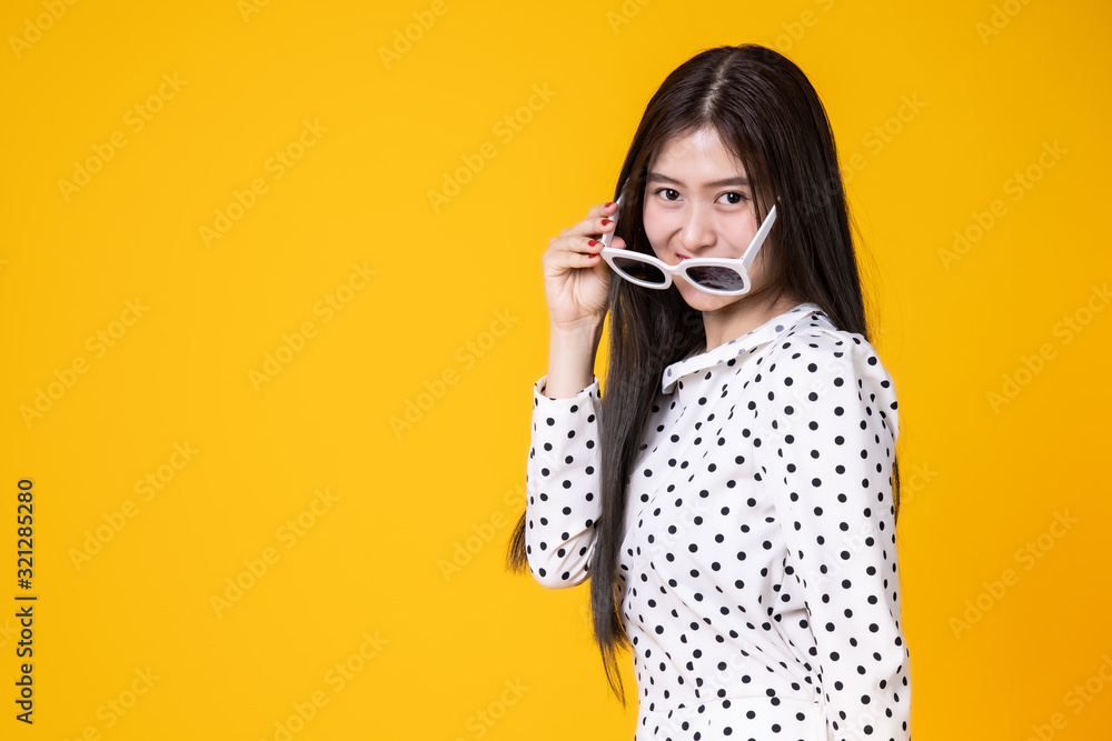 Asian woman in summer casual clothes.She smiling and happy shopping. she lovely attractive shine on yellow background.Summer Surprise Sale concept. Asian woman in summer casual clothes.She smiling and happy shopping. she lovely attractive shine on yellow background.Summer Surprise Sale concept.