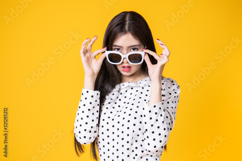 Asian woman in summer casual clothes.She smiling and happy shopping. she lovely attractive shine on yellow background.Summer Surprise Sale concept.