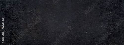 Rustic black grunge background banner. Aged dirty metal surface texture.