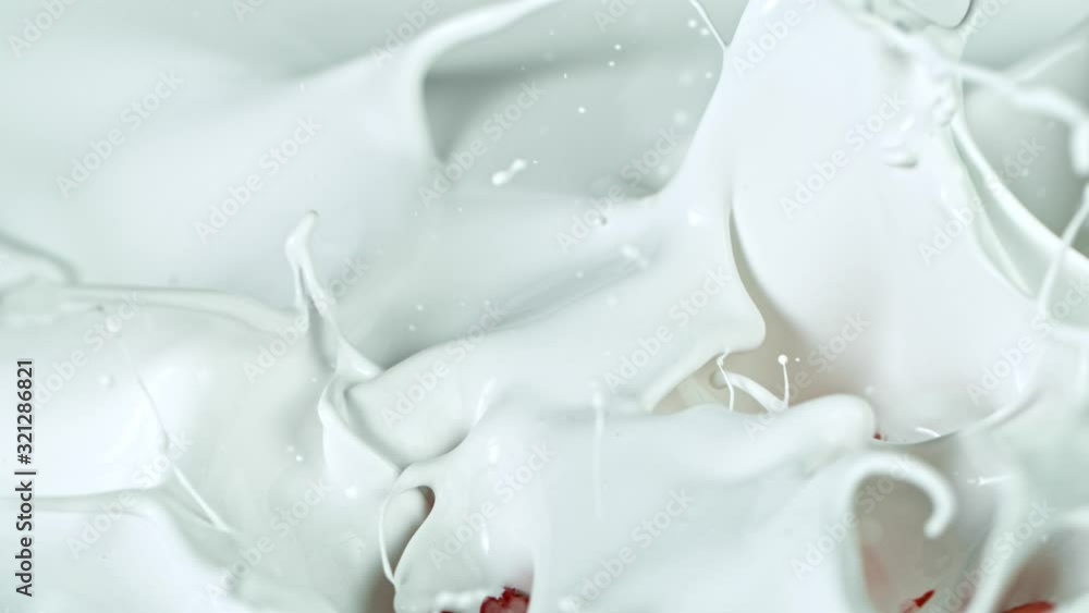 Super Slow Motion Shot of Fresh Strawberries Falling into Cream at 1000fps. Super Slow Motion Shot of Fresh Strawberries Falling into Cream at 1000fps.