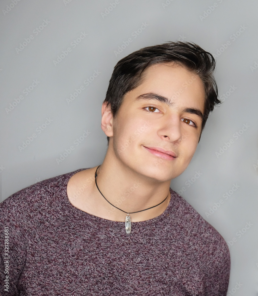 Close-up studio portrait of beautiful smiling young man isolated on grey background. Close-up studio portrait of beautiful smiling young man isolated on grey background.