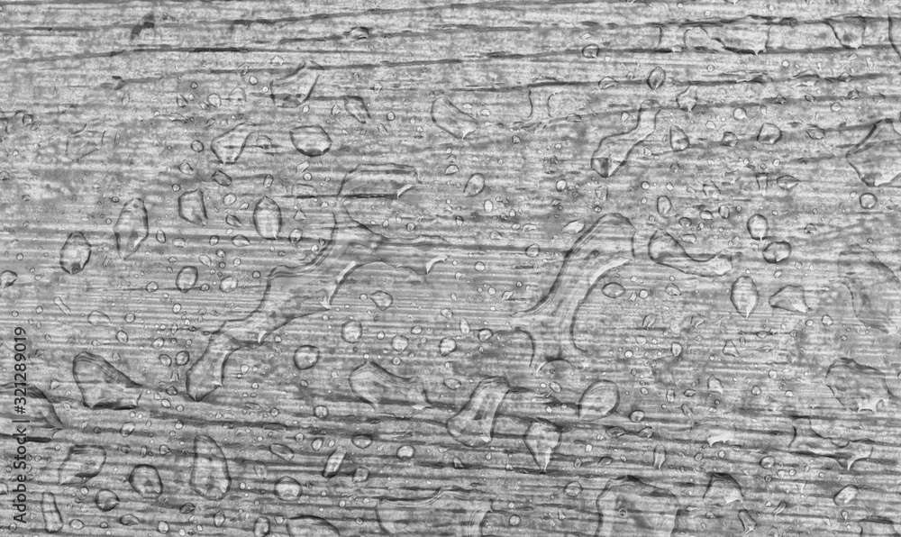 Water drops on a wooden floor surface.Drop of water on wood with raindrop after a rain with copy space. Water drops on a wooden floor surface.Drop of water on wood with raindrop after a rain with copy space.