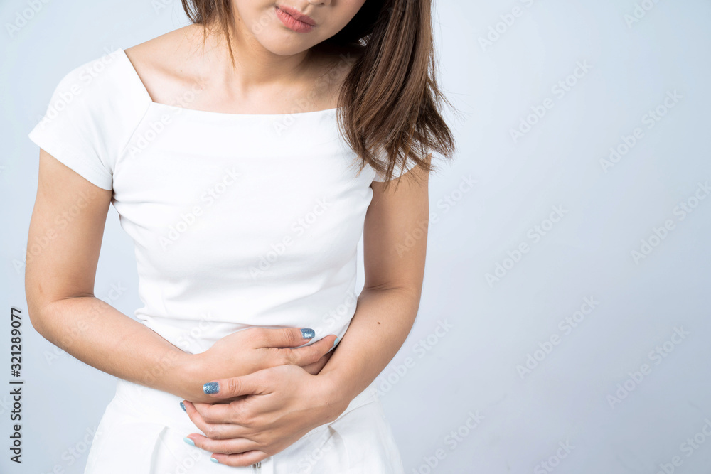 Asian woman with menstruation feels very painful on her stomach Isolated on white. Asian woman with menstruation feels very painful on her stomach Isolated on white.
