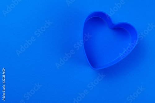  Blue heart shape on blue background. Copy space.