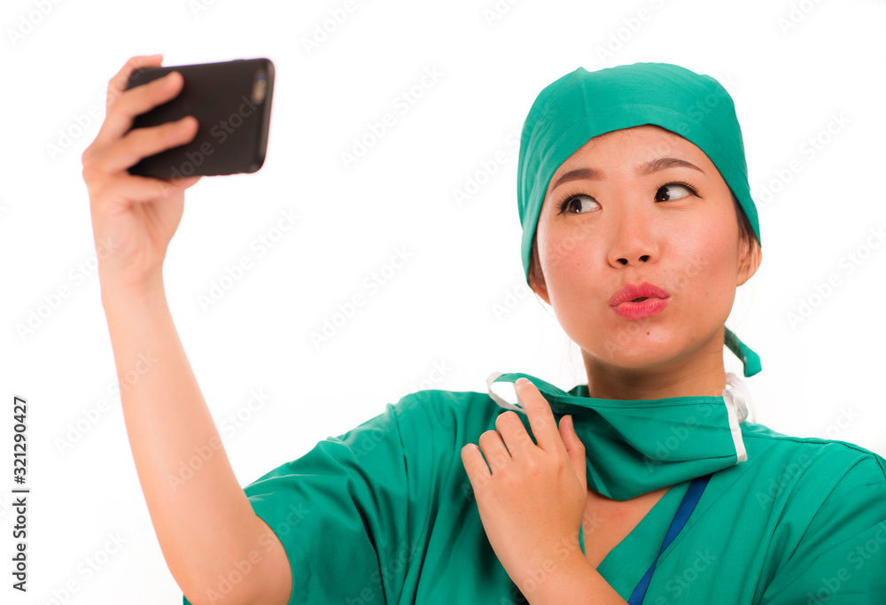 Asian Korean woman as successful taking selfie on hand phone - young beautiful and happy medicine doctor or hospital nurse taking self portrait on mobile phone smiling Asian Korean woman as successful taking selfie on hand phone - young beautiful and happy medicine doctor or hospital nurse taking self portrait on mobile phone smiling