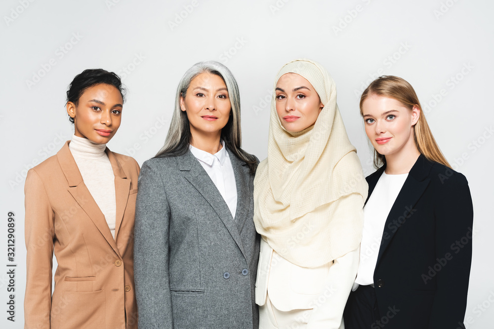 beautiful multicultural businesswomen looking at camera isolated on white beautiful multicultural businesswomen looking at camera isolated on white