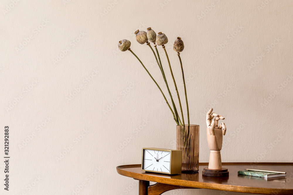 Stylish composition on the design wooden table with gold clock, wooden hand and flowers in vase. Beige background walls. Minimalistic conept of living room. Copy space. Template. Stylish composition on the design wooden table with gold clock, wooden hand and flowers in vase. Beige background walls. Minimalistic conept of living room. Copy space. Template.