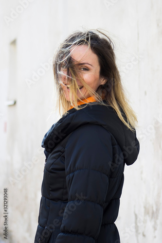 Принти на полотні Woman outdoors with wind-blown hair on her face feels happy