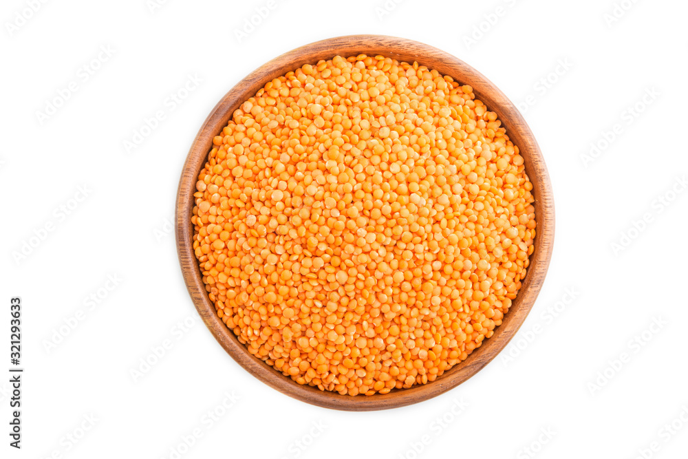 Raw uncooked lentils in a wooden bowl isolated on white background. Top view. Raw uncooked lentils in a wooden bowl isolated on white background. Top view.