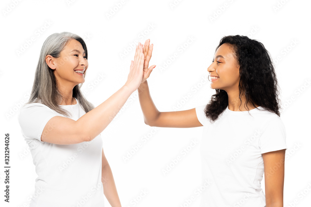 happy african american and asian women giving high five isolated on white happy african american and asian women giving high five isolated on white