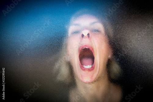 Принти на полотні woman screaming through frosted glass