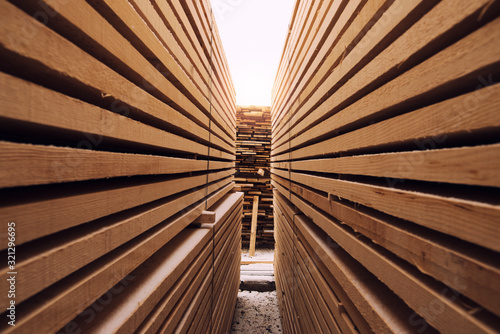 Stack of wooden planks in sawmill lumber yard. photo