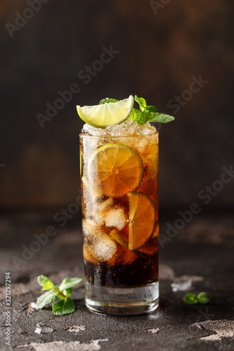 Cuba Libre with brown rum, cola, mint and lime. Cuba Libre or long island iced tea cocktail with strong drinks
