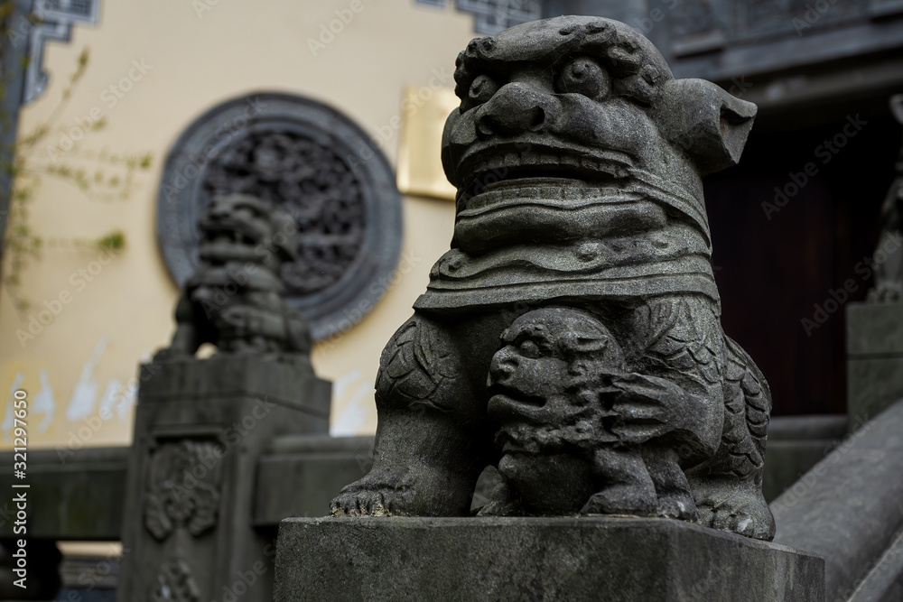 Chongqing, China - March 21, 2018: Sculptures on the railing near the entrance to the ancient Buddhist monastery in the chinese city of Chongqing. Chongqing, China - March 21, 2018: Sculptures on the railing near the entrance to the ancient Buddhist monastery in the chinese city of Chongqing.