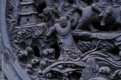 Chongqing, China - March 21, 2018: Bas-relief at an ancient Buddhist temple in the chinese city of Chongqing. Image of Bodhidharma. photo