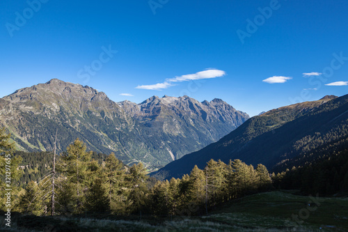 Fototapeta Naklejka Na Ścianę i Meble -  Panorama view of Swiss Alps in Grisons and aerial view of the Val Mesolcina valley and Mesocco town, on a sunny summer day on the Sentiero - Calanca hiking trail in Canton of Graubuenden, Switzerland
