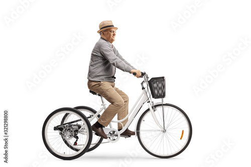 Senior man riding a white tricycle