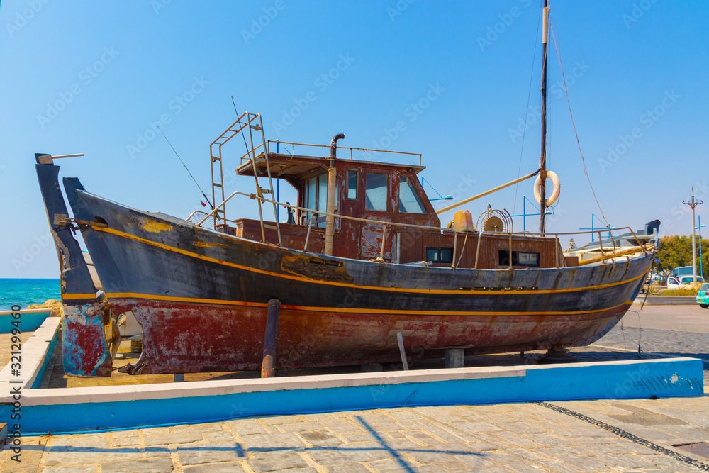 Ayia Napa, Cyprus - September 06, 2019: An old fishing boat stands on the shore.