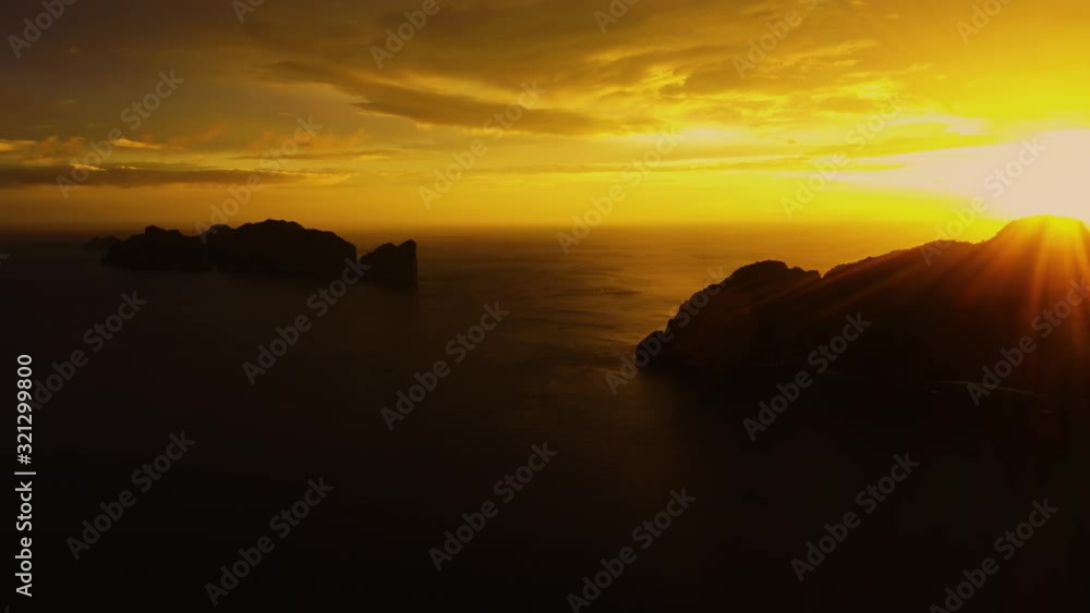 Aerial view of Phi Phi, Maya beach with blue turquoise seawater, mountain hills, and tropical green forest trees at sunset with Andaman sea in Phuket island in summer, Thailand. Nature. Panorama Aerial view of Phi Phi, Maya beach with blue turquoise seawater, mountain hills, and tropical green forest trees at sunset with Andaman sea in Phuket island in summer, Thailand. Nature. Panorama