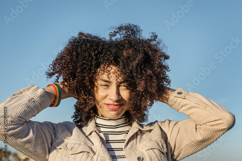 beautiful young black woman with curly afro hair © Raul Mellado