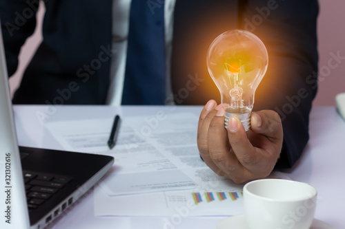 Businessman with a light bulb New ideas with innovative and creative technology.