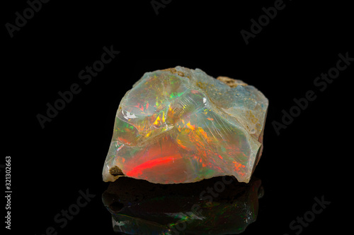 macro mineral stone rare and beautiful opals on a black background