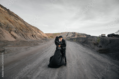 Asian couple in love in black leather clothes walking in nature. Style, fashion, love © Andrii