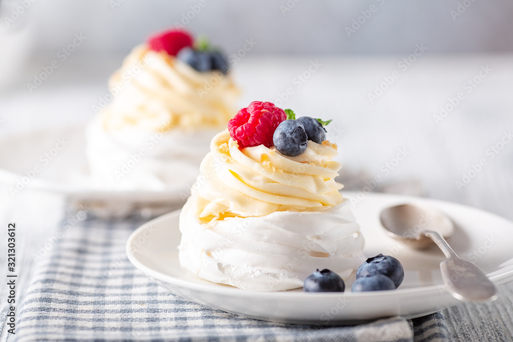 Delicious Pavlova cake with whipped cream and fresh berries. Close-up. Selective focus Delicious Pavlova cake with whipped cream and fresh berries. Close-up. Selective focus