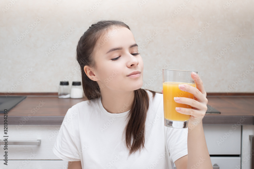 Homemade breakfast. The girl is drinking orange juice. Homemade breakfast. The girl is drinking orange juice.