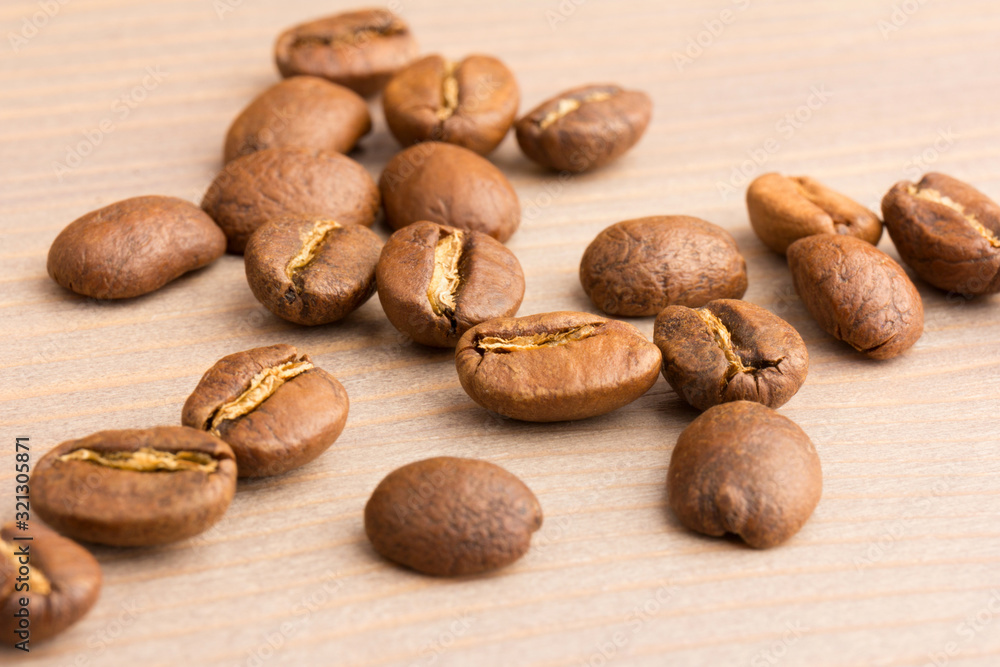 coffee beans. the pile on wooden table. close up coffee beans. the pile on wooden table. close up