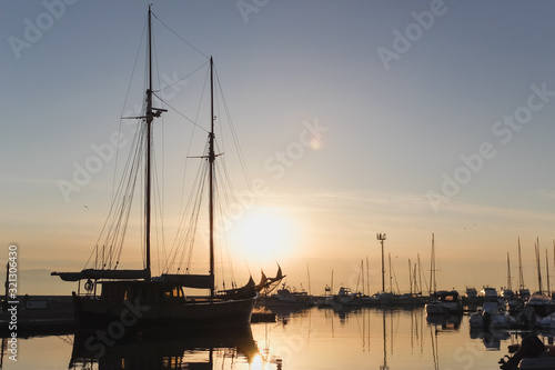 Fototapeta Naklejka Na Ścianę i Meble -  Boat silhouette on the dock of Marina Piccola