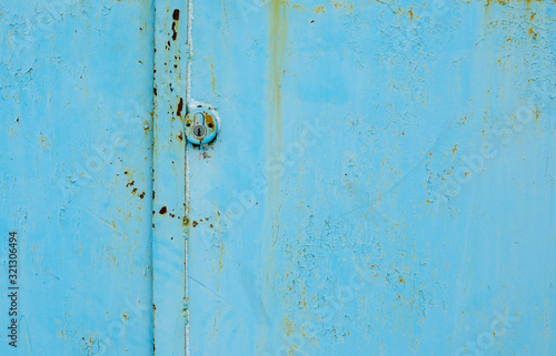 old blue metal door with a hole © Вячеслав 