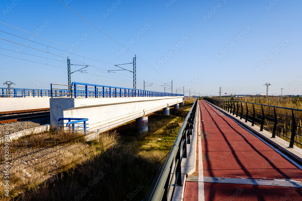 Bike path next to a concrete bridge in a rural area with good infrastructure in Spain. Bike path next to a concrete bridge in a rural area with good infrastructure in Spain.