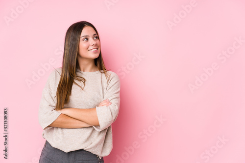 Young caucasian woman posing isolated smiling confident with crossed arms.