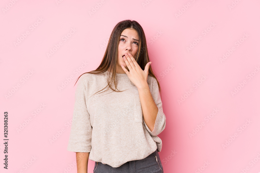 Young caucasian woman posing isolated yawning showing a tired gesture covering mouth with hand. Young caucasian woman posing isolated yawning showing a tired gesture covering mouth with hand.