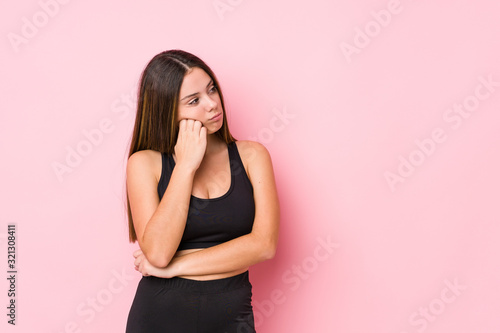 Young fitness caucasian woman isolated who feels sad and pensive  looking at copy space.
