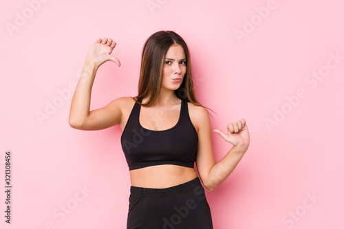 Young fitness caucasian woman isolated feels proud and self confident, example to follow.