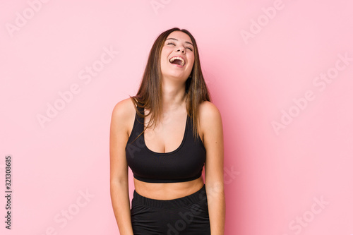 Young fitness caucasian woman isolated relaxed and happy laughing, neck stretched showing teeth. © Asier