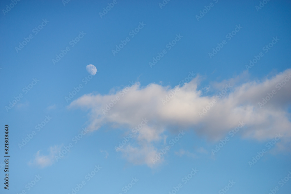 retail of blue cloudy sky with the moon retail of blue cloudy sky with the moon